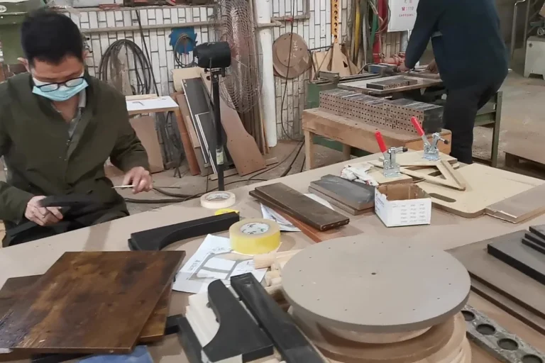 Furniture samples and components reviewed on a development workbench