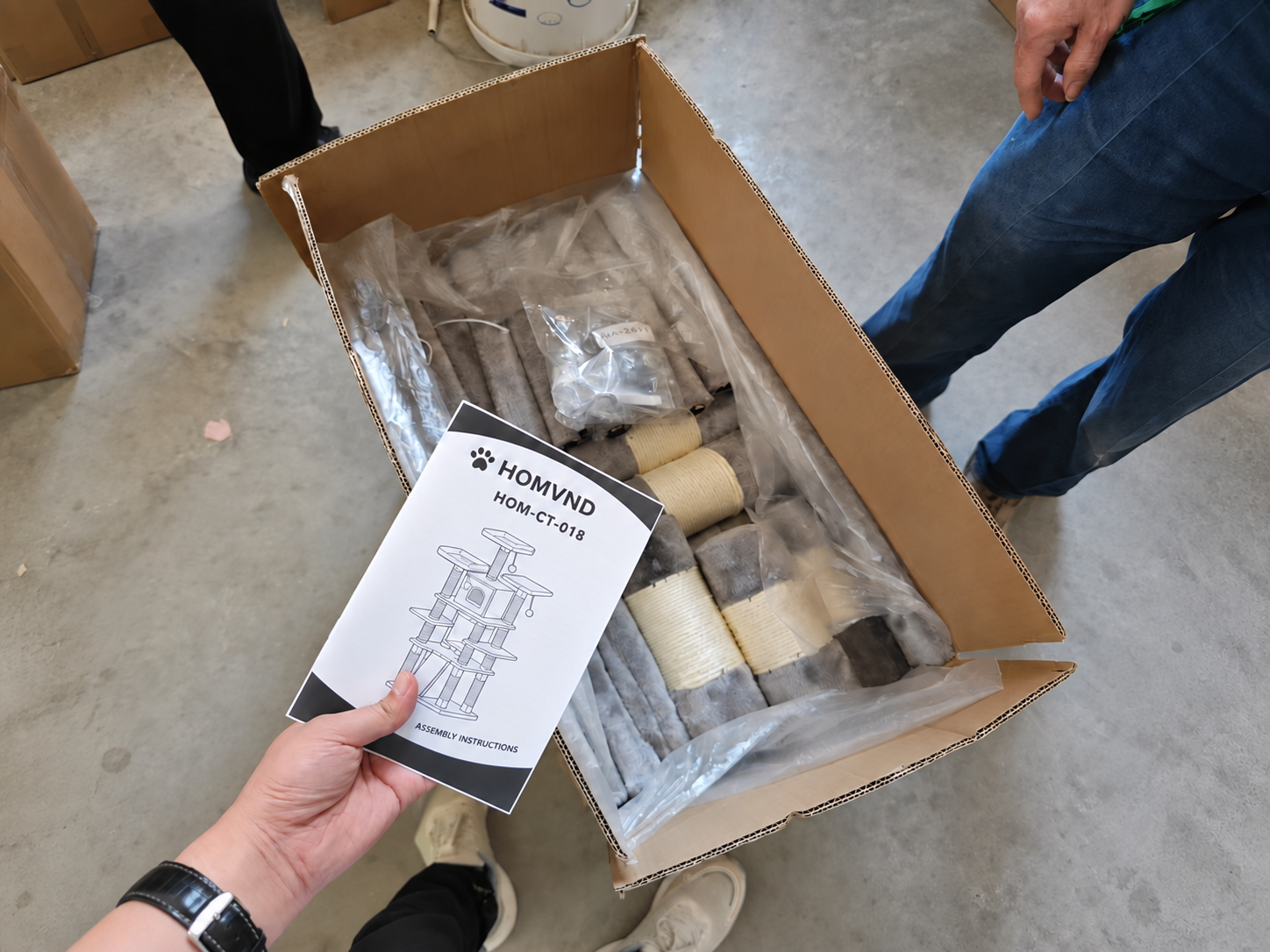 Flat-pack cat tree packaging reviewed with components, hardware and assembly instructions