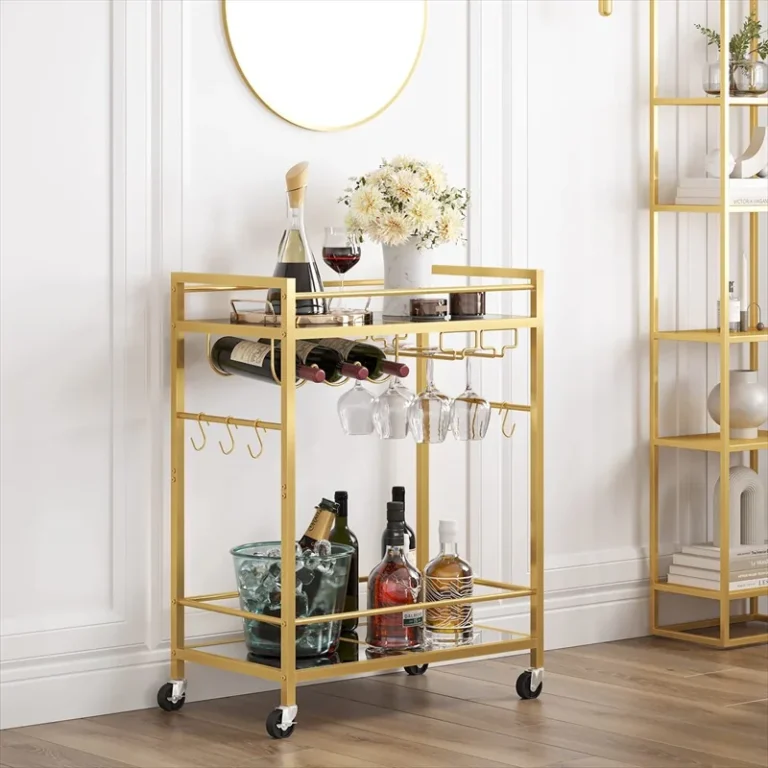 Gold-finish two-tier bar cart with mirrored shelves and hanging glasses
