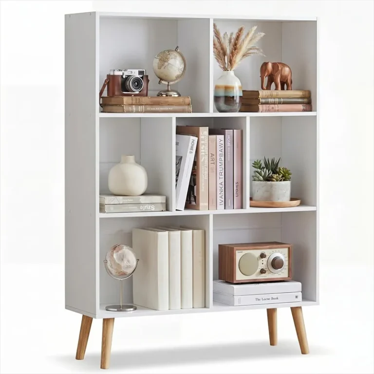 White seven-cubby bookcase with books and ornaments on raised legs
