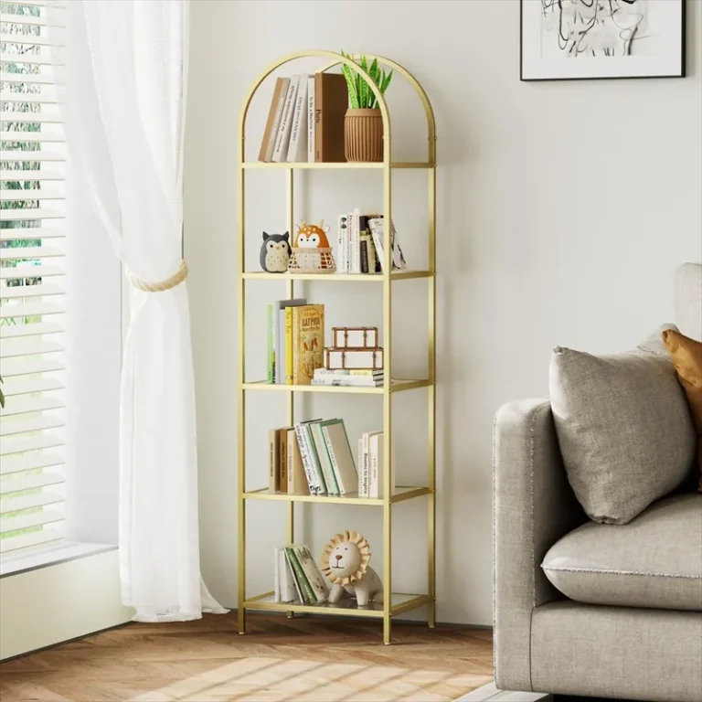 Arched gold-finish bookcase with five glass shelves beside a sofa