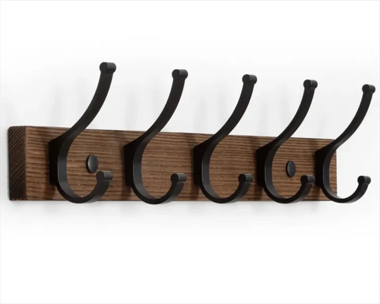 Wall coat rail with five double hooks on a brown backboard