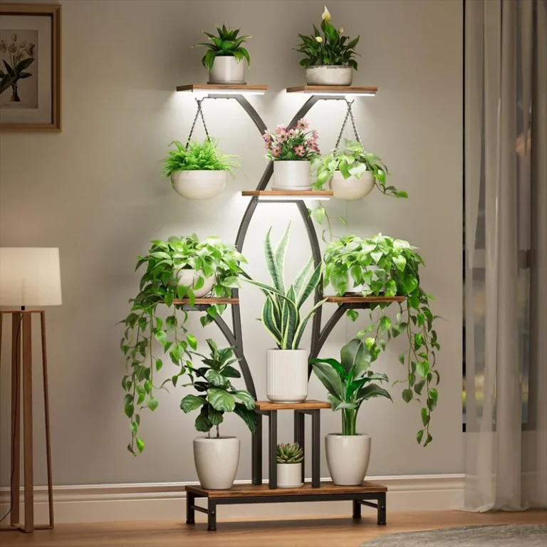 X-shaped plant stand holding potted and hanging plants with lights on