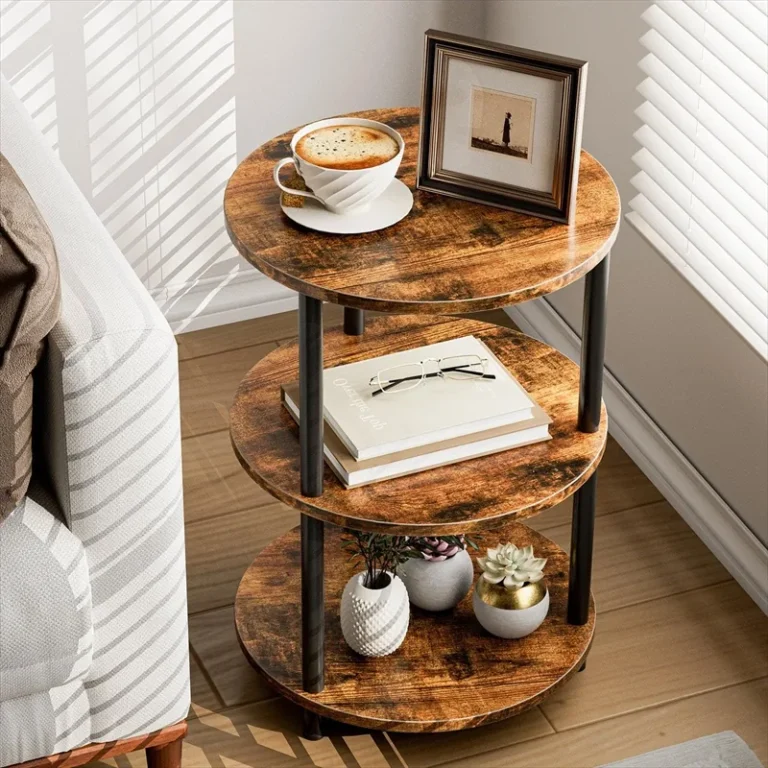 Round three-tier side table beside a sofa with books and a cup