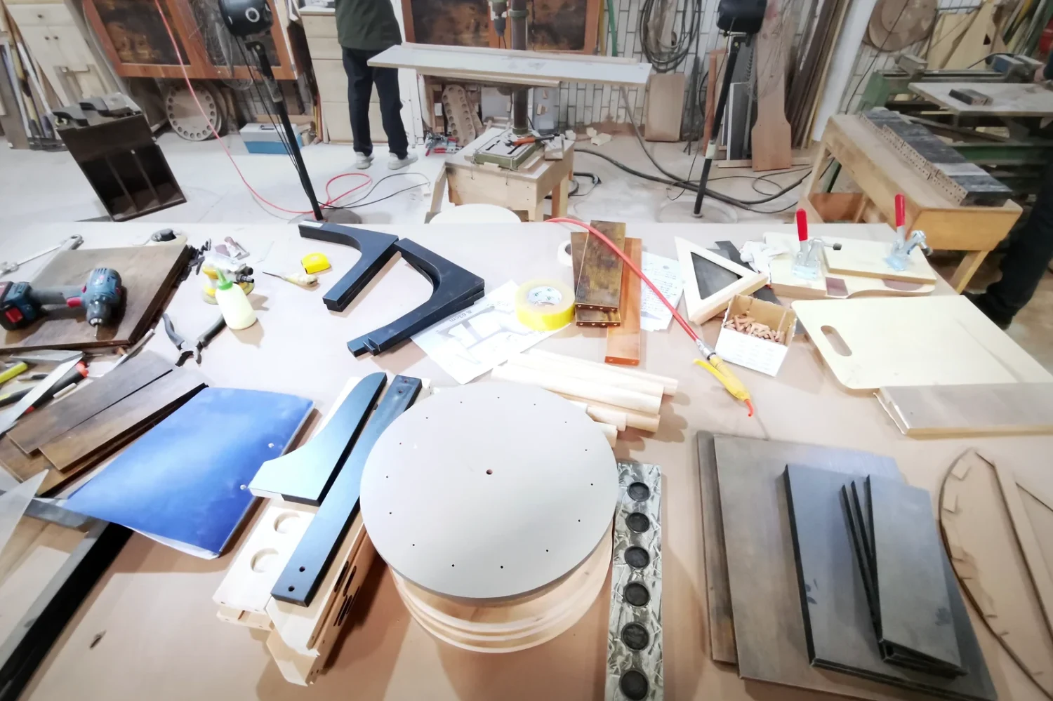 Furniture components, material samples and fixtures arranged on a development worktable